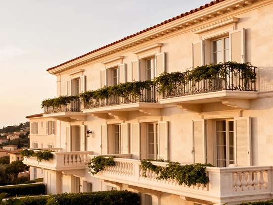 Mediterranean coastal residence with stone facade and balconies
